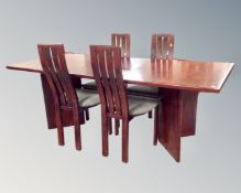 A 1980s rosewood twin pedestal extending dining table with leaf together with a set of four