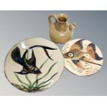 Two studio pottery plates by Puigdemont pottery decorated with fish together with a pottery jug