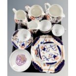 A tray of antique English Imari tea china, set of three graduated jugs,
