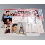 A tray containing Elvis Presley memorabilia including a signed portrait photograph (signature