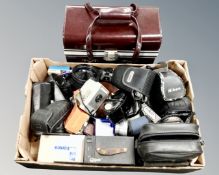 A vintage stitched leather camera case together with a box containing vintage and later cameras