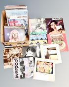 A box containing vinyl LPs including The Rolling Stones, Frankie Goes To Hollywood, The Clash,