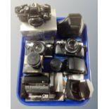 A tray containing Olympus cameras and accessories including three OM-10 cameras, lenses, winders,