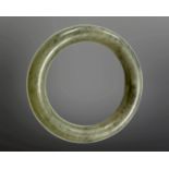 A carved jade circular bangle, inner diameter 58mm.