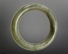 A carved jade circular bangle, inner diameter 58mm.