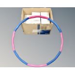 A box containing a quantity of weighted hula-hoops.