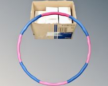 A box containing a quantity of weighted hula-hoops.