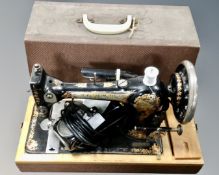 A vintage Jones sewing machine, in case, electrified.