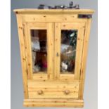 A pine double door glazed cabinet converted to a vivarium with accessories