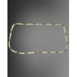 An Edwardian 9ct gold cultured pearl and turquoise single-strand necklace, length 36cm.