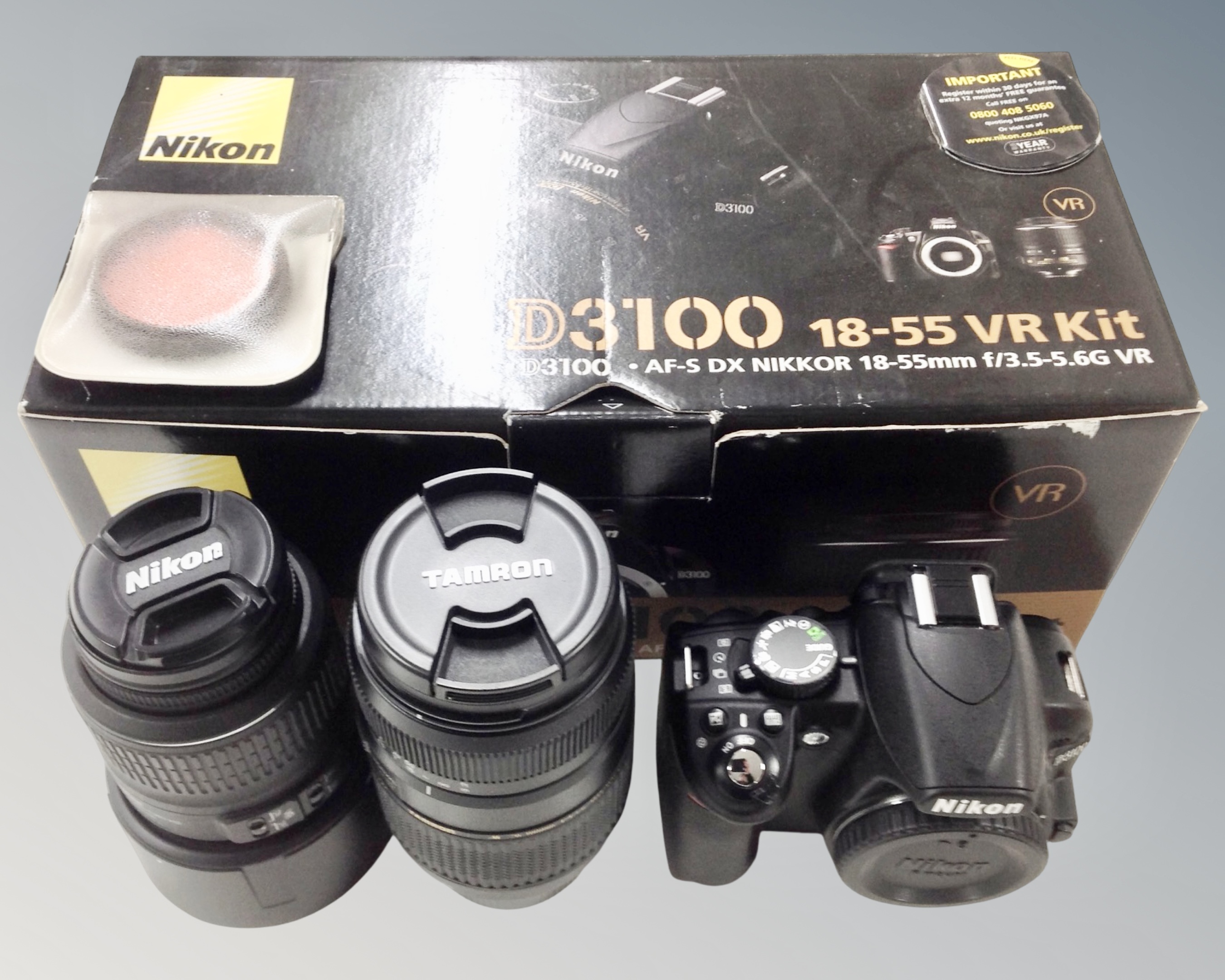 A Nikon D3100 18-55 VR camera kit, in original box, together with a Tanron for Nikon lens.