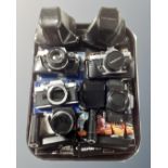 A tray containing three Olympus camera bodies, two OM-10s, an OM-2 and an OM-40,