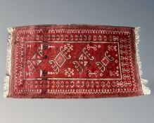 An Afghan rug, 78cm by 130cm.