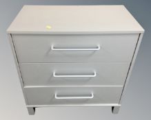 A contemporary three drawer chest in a silver finish.