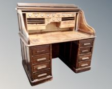 A 19th century oak roll topped desk,