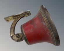 An antique brass hand painted wall bell