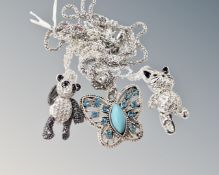 A white metal articulated encrusted cat figure on chain,