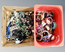 A box containing a large quantity of costume jewellery and bangles.