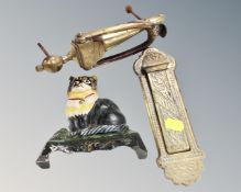 A vintage cast iron cat doorstop together with an antique brass door knocker and letter box.