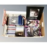 A box containing Elvis collectibles including a set of five collector's plates with shelf,
