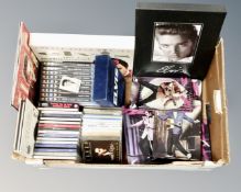 A box containing Elvis collectibles including a set of five collector's plates with shelf,