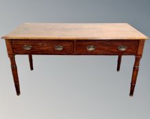A George III mahogany table fitted with two drawers,