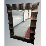 A contemporary mirror in wave frame, 92cm by 122cm.