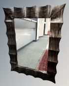 A contemporary mirror in wave frame, 92cm by 122cm.