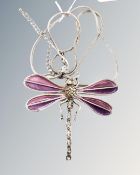 A large white metal plique-à-jour amethyst colour dragonfly brooch.