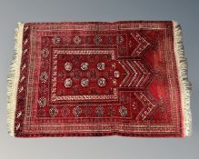An Afghan prayer rug, 83cm by 108cm.