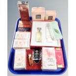 A tray containing beauty products including Yves Saint Laurent Opium perfume,