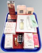 A tray containing beauty products including Yves Saint Laurent Opium perfume,