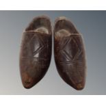 A pair of antique wooden miniature clogs