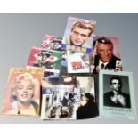 A tray containing vintage calendars including James Dean and Marilyn Monroe,