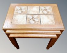 A nest of three 20th century Danish teak tile topped tables,