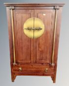 A Chinese style double door cabinet fitted with drawer beneath,