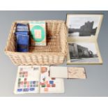A basket containing a photograph album of monochrome photos of Newcastle and London,