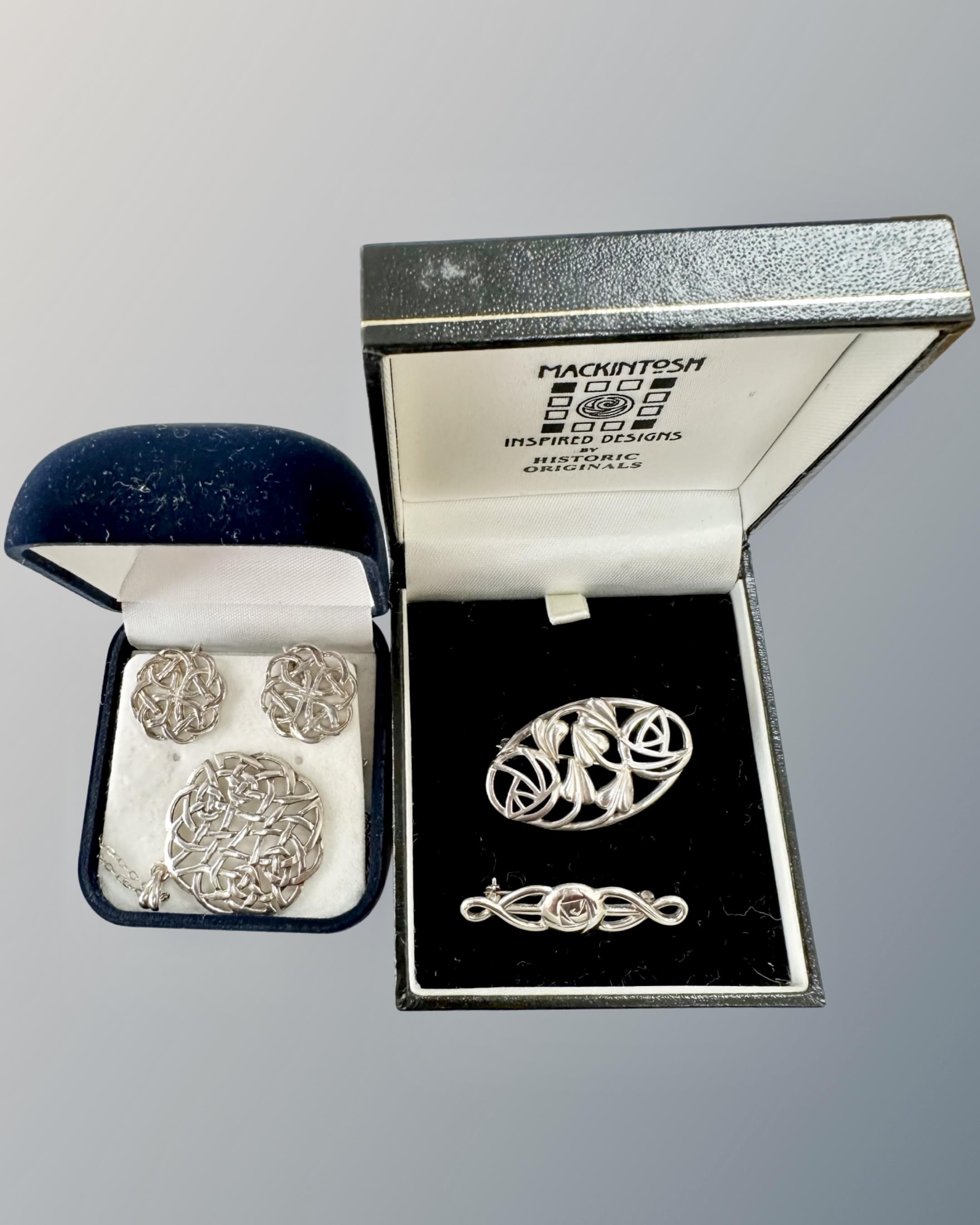 Two silver Charles Rennie Mackintosh design brooches, Celtic silver pendant and matching earrings.