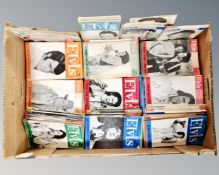 A box containing a quantity of vintage Elvis Monthly magazines.