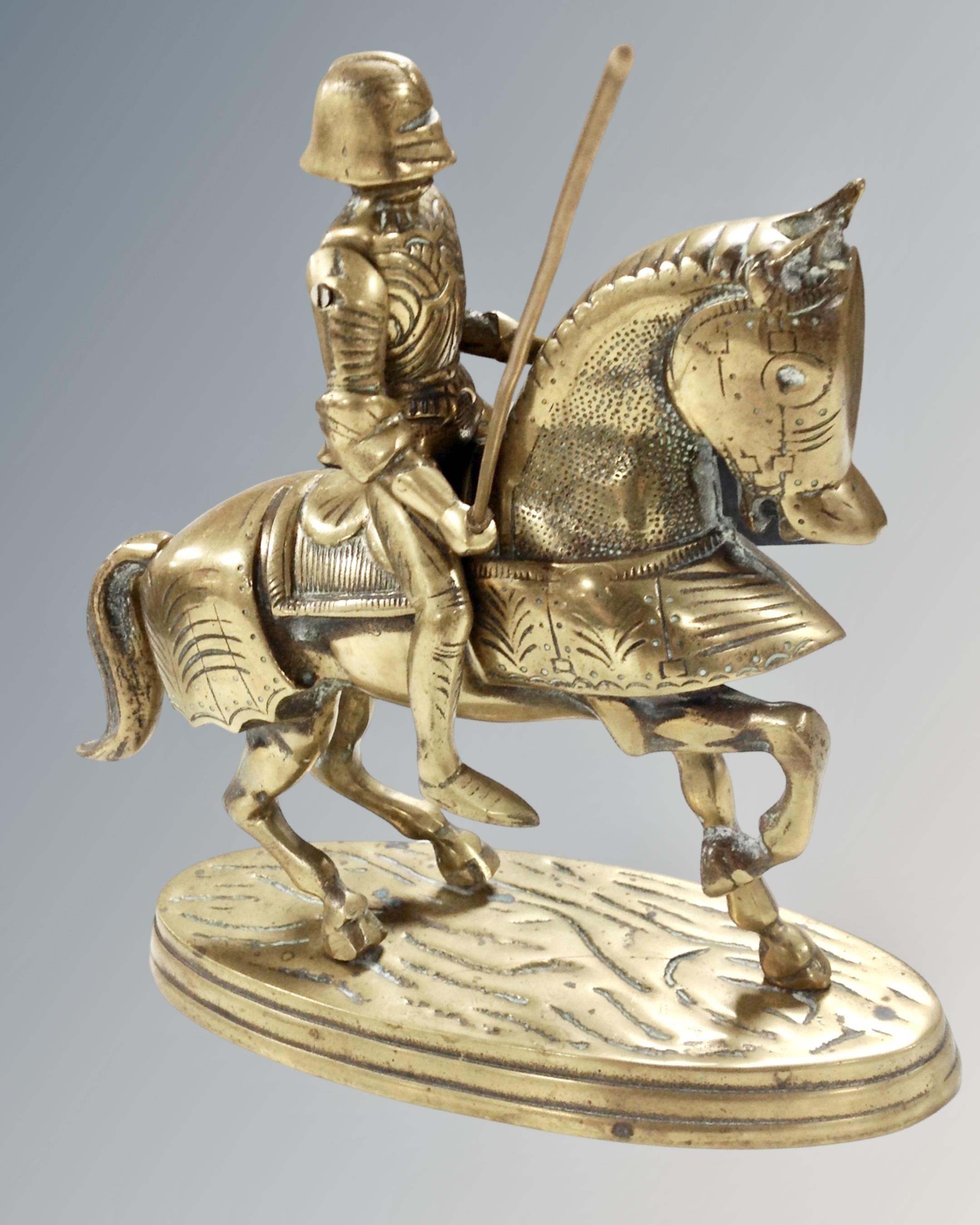 A heavy brass figure of a knight on horseback,