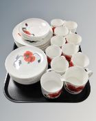 A collection of 37 pieces of Wedgwood Susie Cooper design corn poppy tea and dinner china.