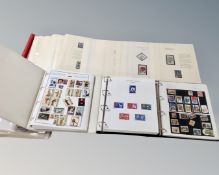 Four albums containing world stamps including flowers and silks.