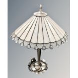 A contemporary table lamp with Tiffany style leaded glass shade.