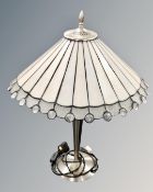 A contemporary table lamp with Tiffany style leaded glass shade.