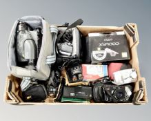 A box containing assorted instant and digital cameras, camera bags, Hitachi video camera,
