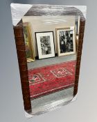 A contemporary mirror in a leather effect frame, 63cm by 103cm.