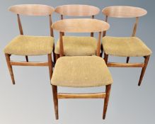 A set of four mid-20th century teak dining chairs.