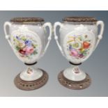 A pair of twin handled Victorian transfer printed vases on metal bases with liners