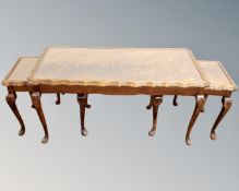 A nest of three mahogany and beech glass topped tables.