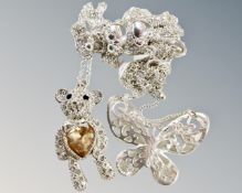 An encrusted white metal articulated teddy bear with amber coloured inset heart together with a